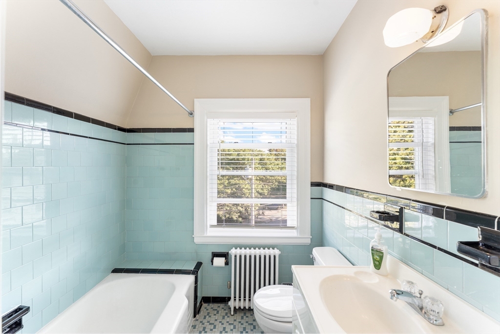 131 Irving Avenue, Unit 3 Providence, RI 02906 - Photo 12 of 14 a bathroom with a sink a toilet and a window