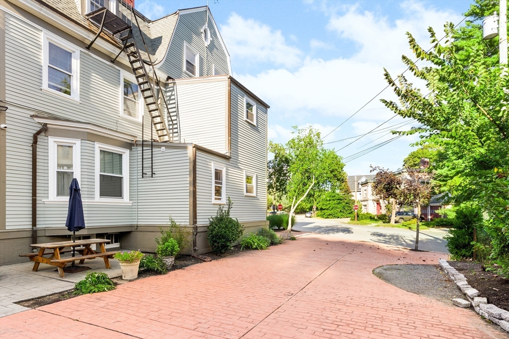 131 Irving Avenue, Unit 3 Providence, RI 02906 - Photo 14 of 14 a front view of a house with a yard