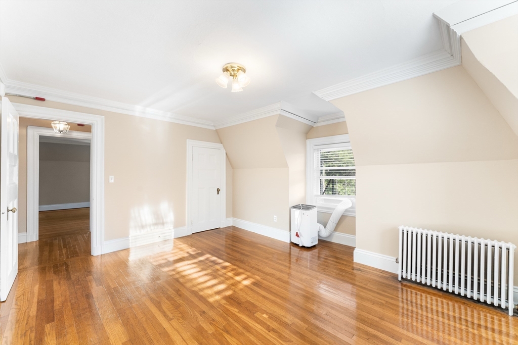 131 Irving Avenue, Unit 3 Providence, RI 02906 - Photo 5 of 14 a bedroom with a bed and wooden floor