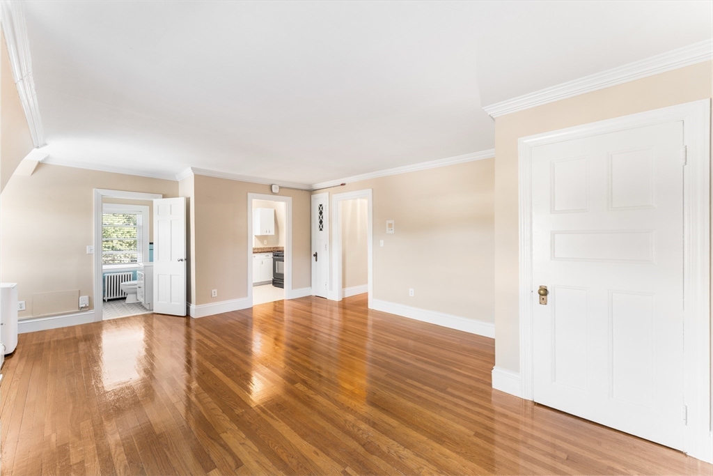131 Irving Avenue, Unit 3 Providence, RI 02906 - Photo 7 of 14 a view of an empty room with wooden floor and a window