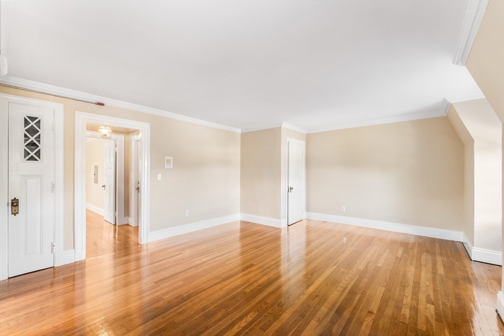131 Irving Avenue, Unit 3 Providence, RI 02906 - Photo 8 of 14 a view of an empty room with wooden floor