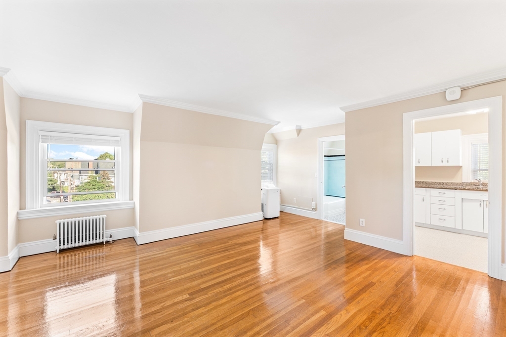131 Irving Avenue, Unit 3 Providence, RI 02906 - Photo 10 of 14 a view of an empty room with window and wooden floor