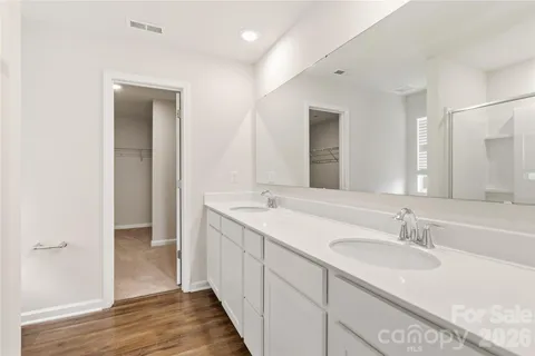 a bathroom with a double vanity sink and a mirror