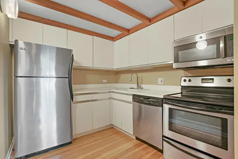 a kitchen with a refrigerator stove and microwave