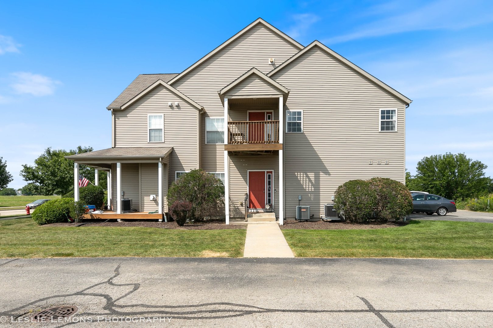 a front view of a house with a yard and plants