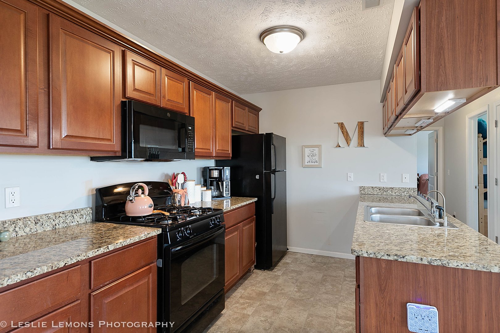 581 Stonegate Drive Sycamore, IL 60178 - Photo 21 of 23 a kitchen with granite countertop a sink stove and refrigerator