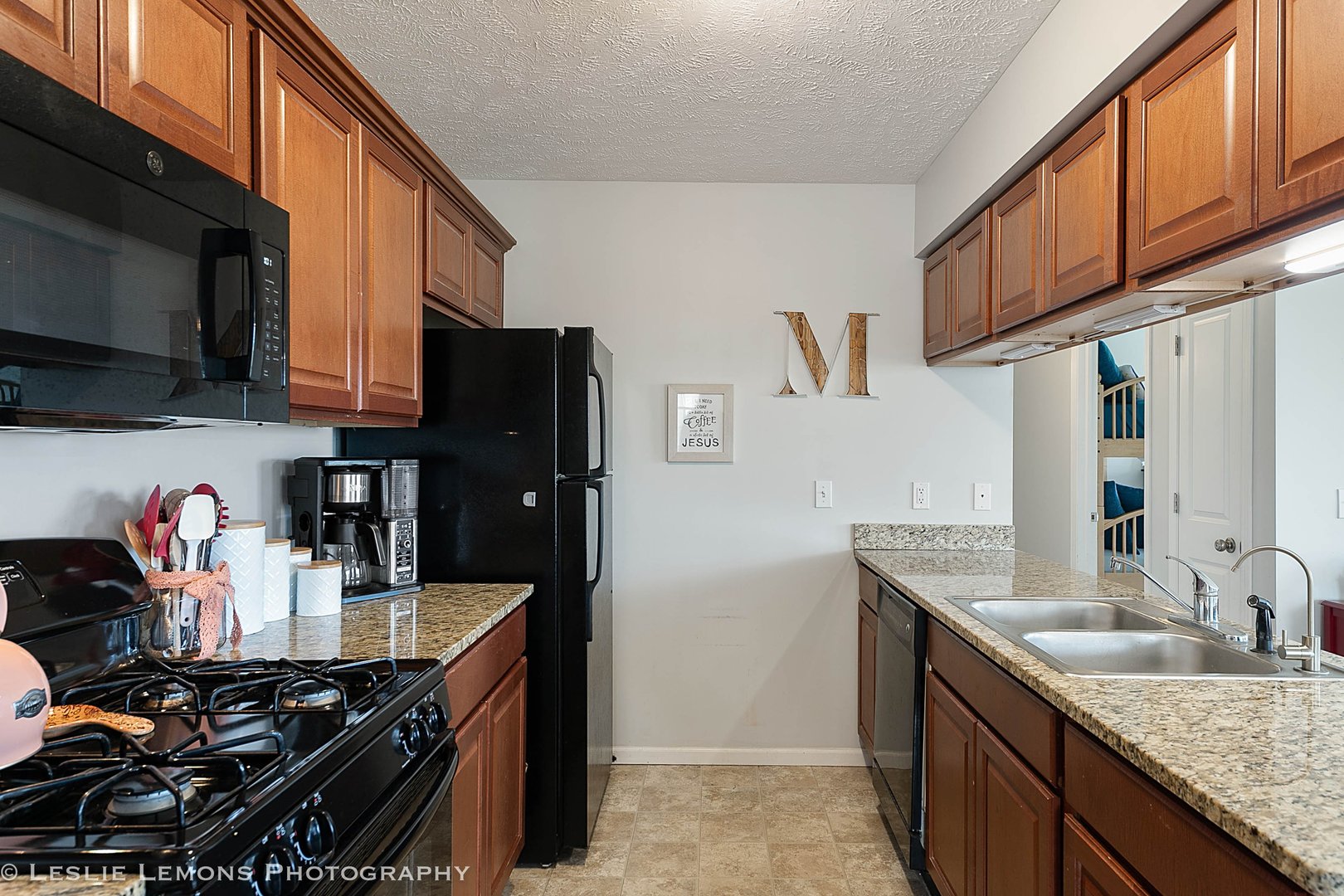 581 Stonegate Drive Sycamore, IL 60178 - Photo 22 of 23 a kitchen with stainless steel appliances granite countertop a sink stove and refrigerator