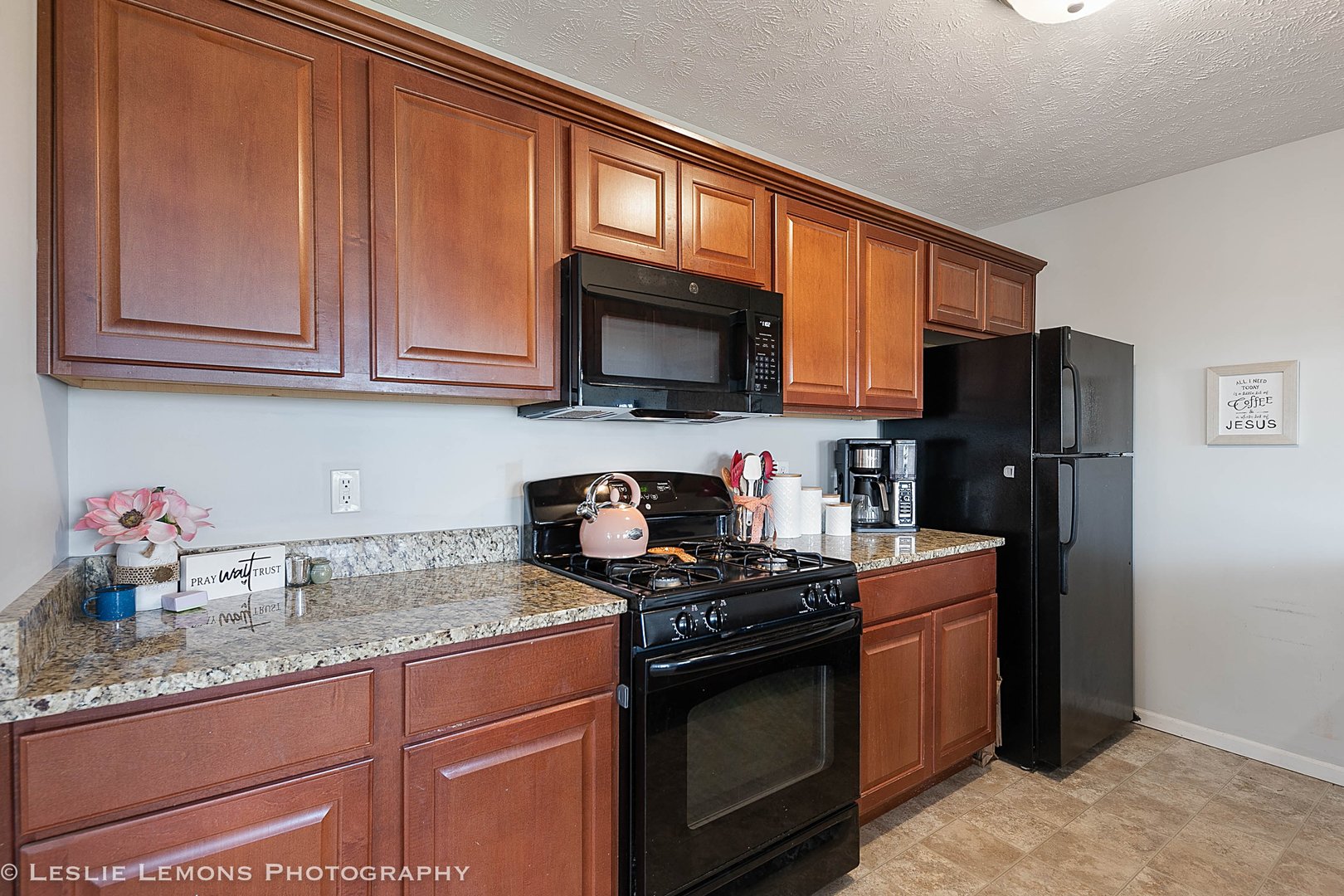 581 Stonegate Drive Sycamore, IL 60178 - Photo 6 of 23 a kitchen with granite countertop stainless steel appliances a refrigerator stove top oven and sink