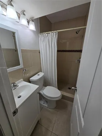 a bathroom with a toilet sink and shower