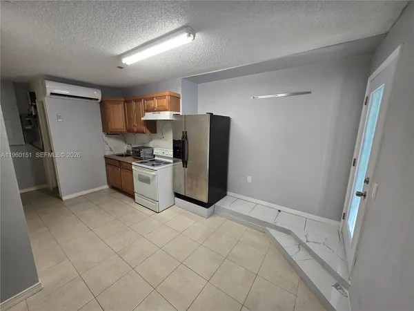 a kitchen with stainless steel appliances a refrigerator and a stove