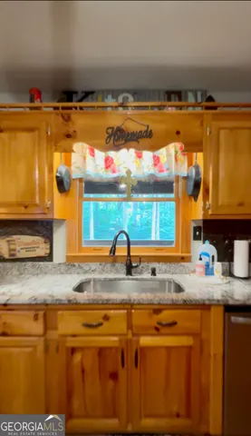 a kitchen with stainless steel appliances granite countertop a sink and a granite countertops