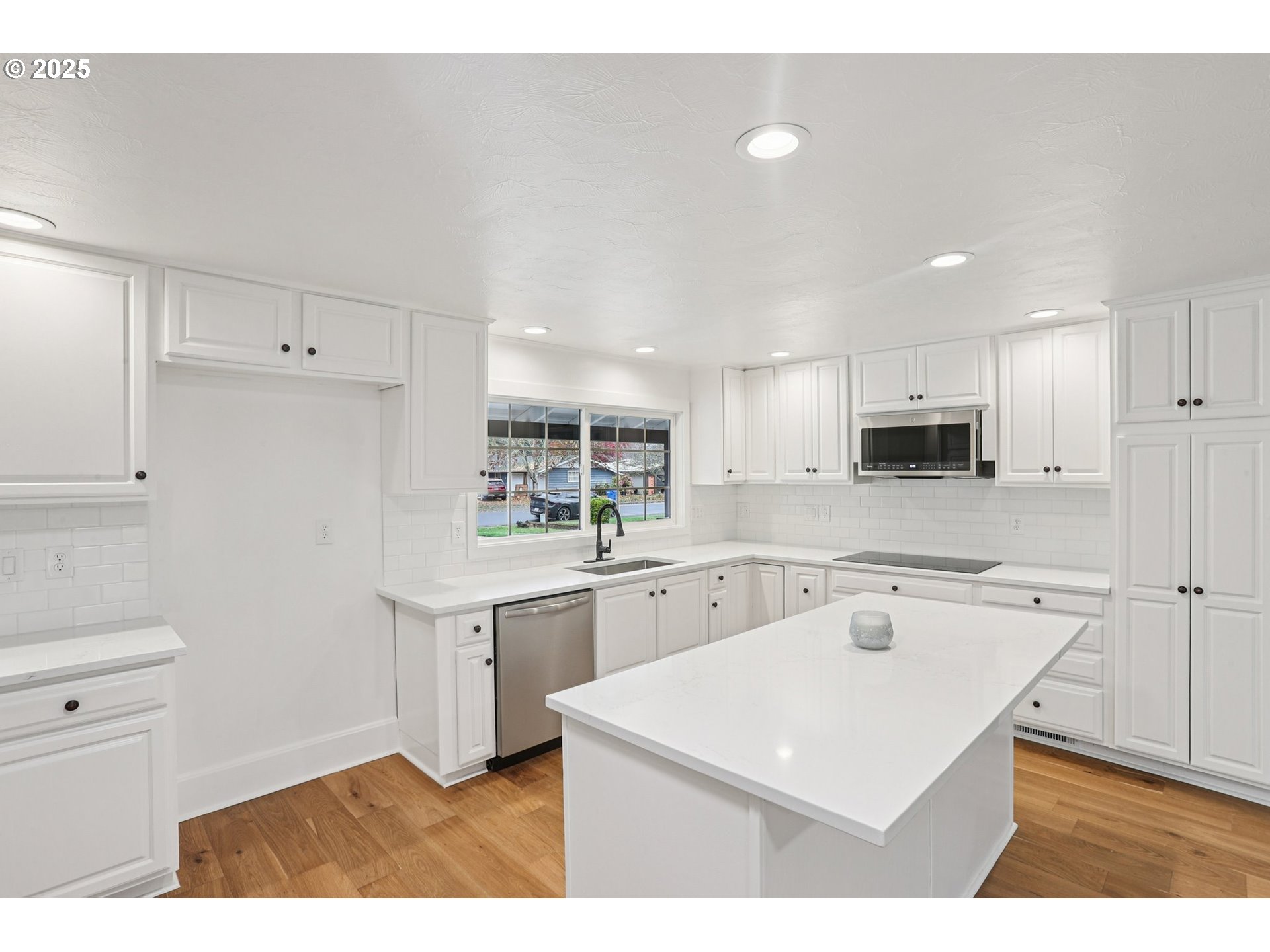 870 Rafael Avenue North Keizer, OR 97303 - Photo 17 of 37 a kitchen with a sink a stove a refrigerator and white cabinets