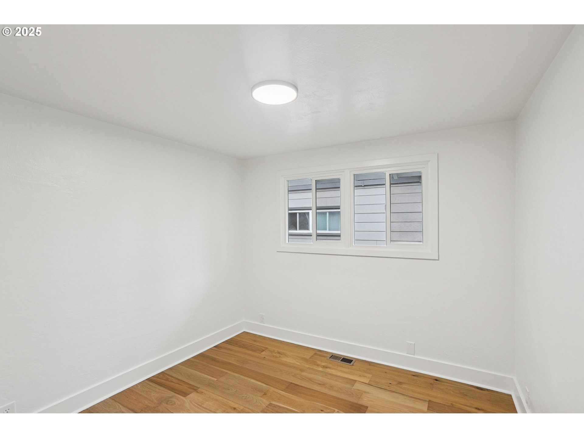 870 Rafael Avenue North Keizer, OR 97303 - Photo 22 of 37 a view of an empty room with wooden floor and a window