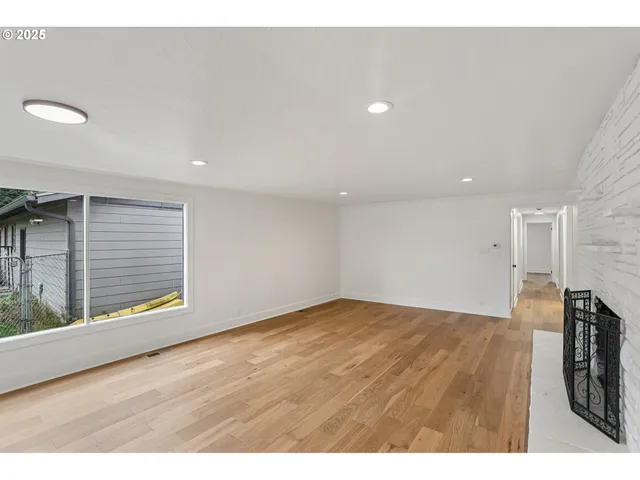 a view of kitchen with kitchen island white cabinets and wooden floor