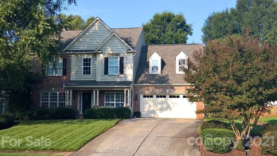 311 Matthews Estates Road Matthews, NC 28105 - Photo 1 of 27 a front view of a house with a yard and garage