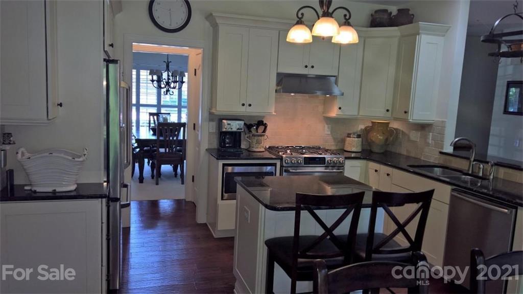 311 Matthews Estates Road Matthews, NC 28105 - Photo 12 of 27 a kitchen with a table chairs and a stove