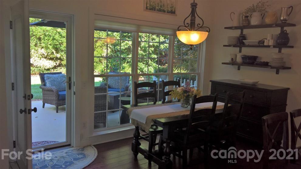 311 Matthews Estates Road Matthews, NC 28105 - Photo 13 of 27 a view of a dining room with furniture window and wooden floor