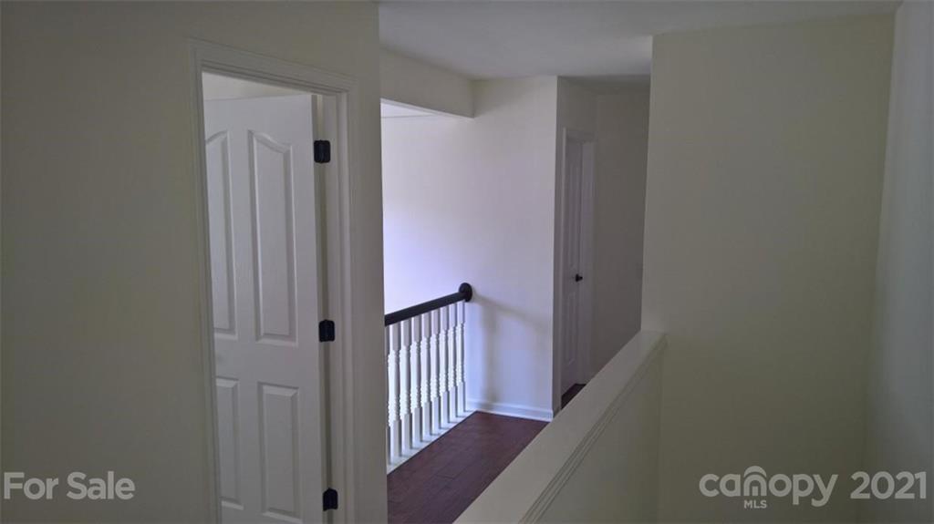 311 Matthews Estates Road Matthews, NC 28105 - Photo 15 of 27 a view of a hallway with wooden floor