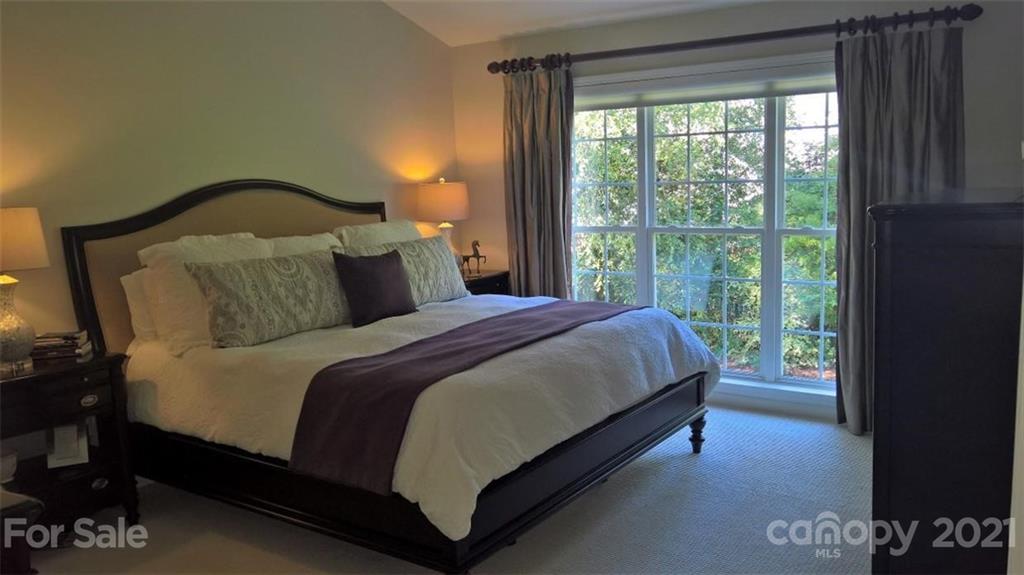 311 Matthews Estates Road Matthews, NC 28105 - Photo 16 of 27 a large bed sitting in a bedroom next to a window