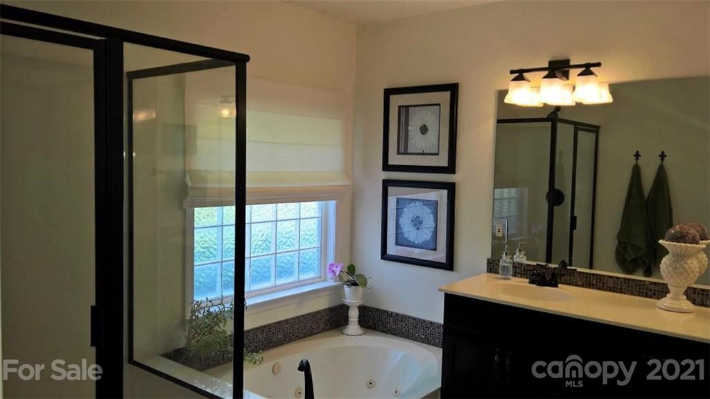 311 Matthews Estates Road Matthews, NC 28105 - Photo 18 of 27 a bathroom with a sink vanity and a mirror