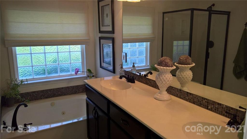 311 Matthews Estates Road Matthews, NC 28105 - Photo 19 of 27 a bathroom with a tub sink and mirror