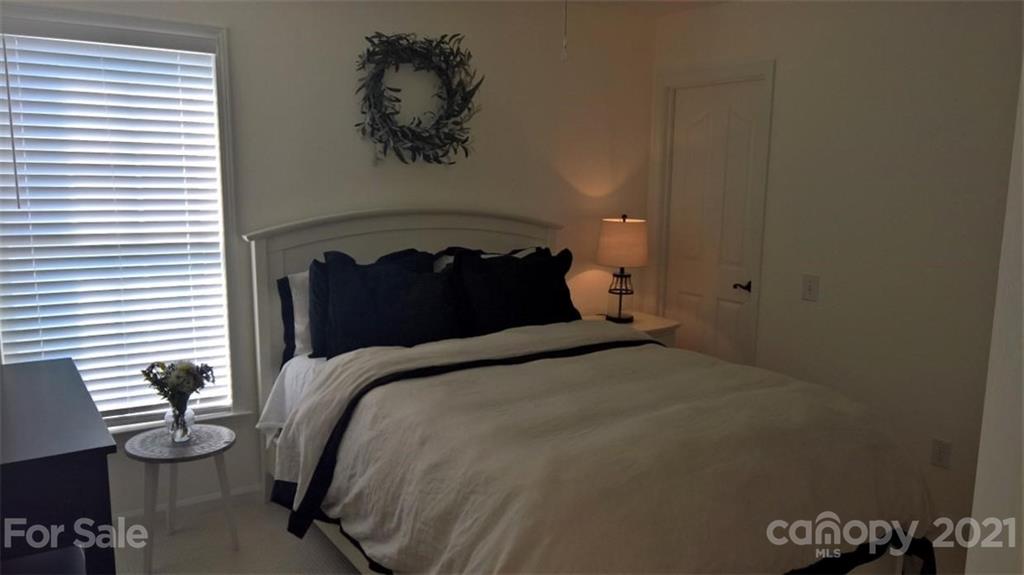 311 Matthews Estates Road Matthews, NC 28105 - Photo 21 of 27 a bedroom with a bed and a window