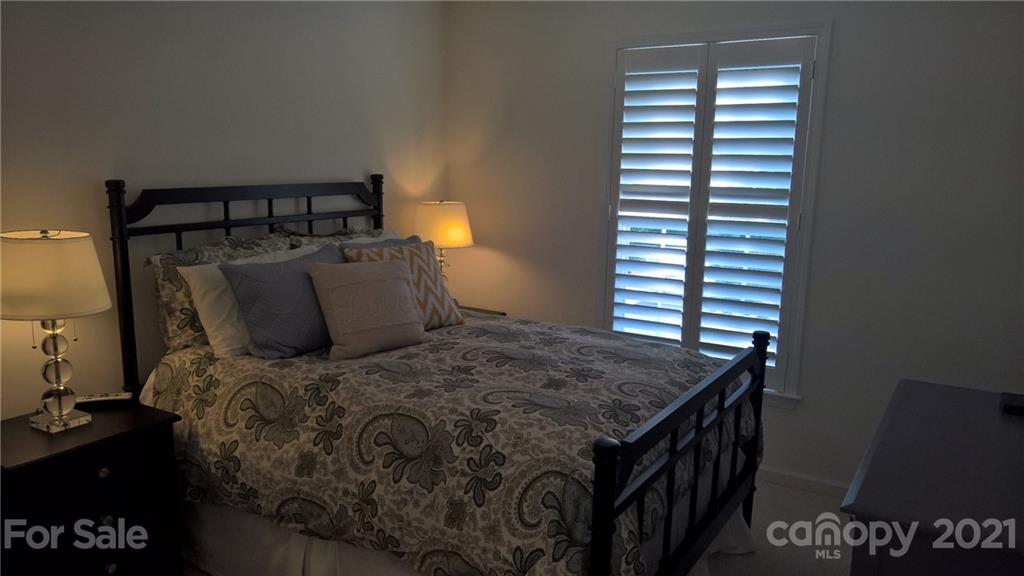311 Matthews Estates Road Matthews, NC 28105 - Photo 23 of 27 a bed sitting in a bedroom next to a window