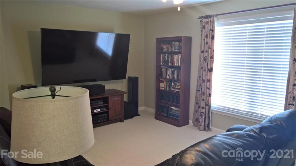 311 Matthews Estates Road Matthews, NC 28105 - Photo 26 of 27 a living room with a bed furniture and a flat screen tv