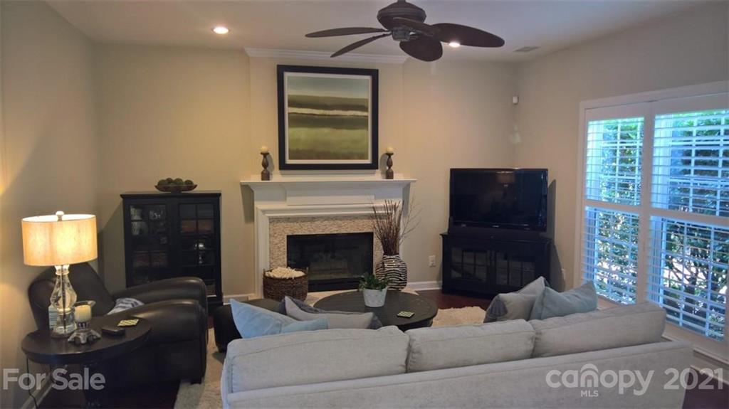 311 Matthews Estates Road Matthews, NC 28105 - Photo 8 of 27 a living room with furniture and a fireplace
