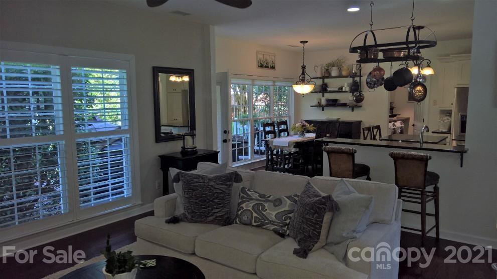 311 Matthews Estates Road Matthews, NC 28105 - Photo 9 of 27 a living room with furniture a chandelier and a dining table
