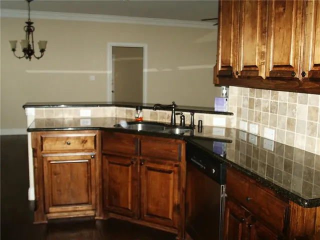 a kitchen with a sink and a refrigerator