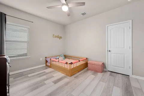 a living room with a bed and window