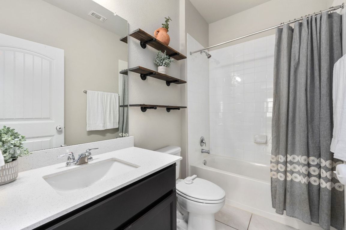6701 Janes Ranch Road Austin, TX 78744 - Photo 16 of 36 a bathroom with a sink a toilet and shower