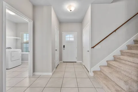 a view of a hallway with bathroom and a bathroom