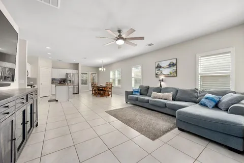 a living room with furniture and kitchen view