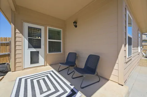 a view of a two chairs in the balcony