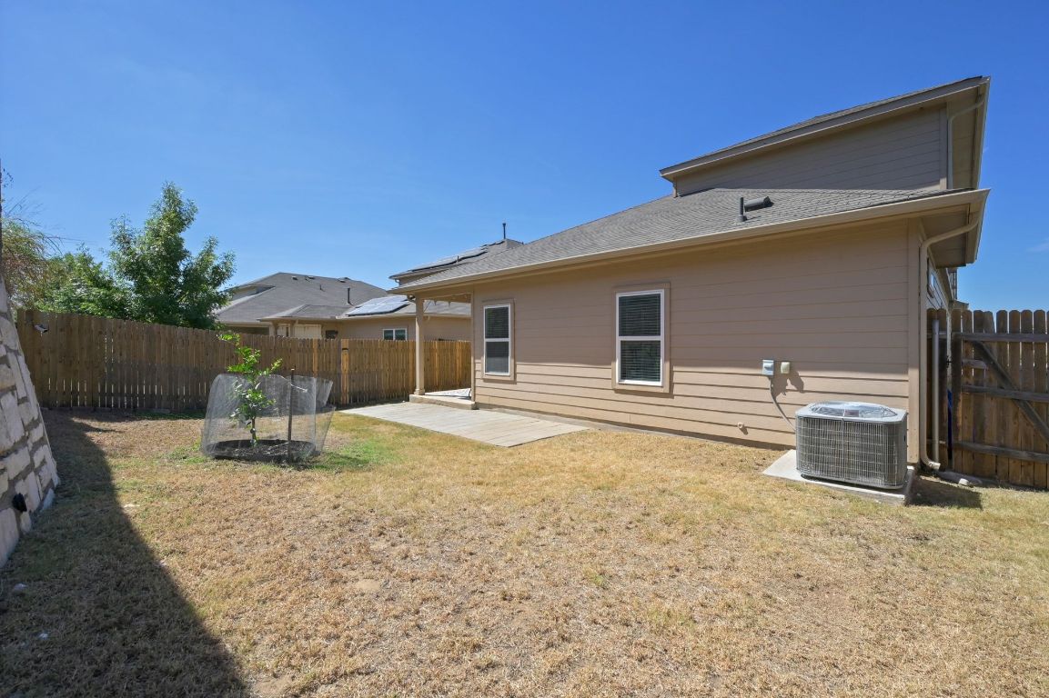 6701 Janes Ranch Road Austin, TX 78744 - Photo 26 of 36 a backyard of a house with fire pit and chairs