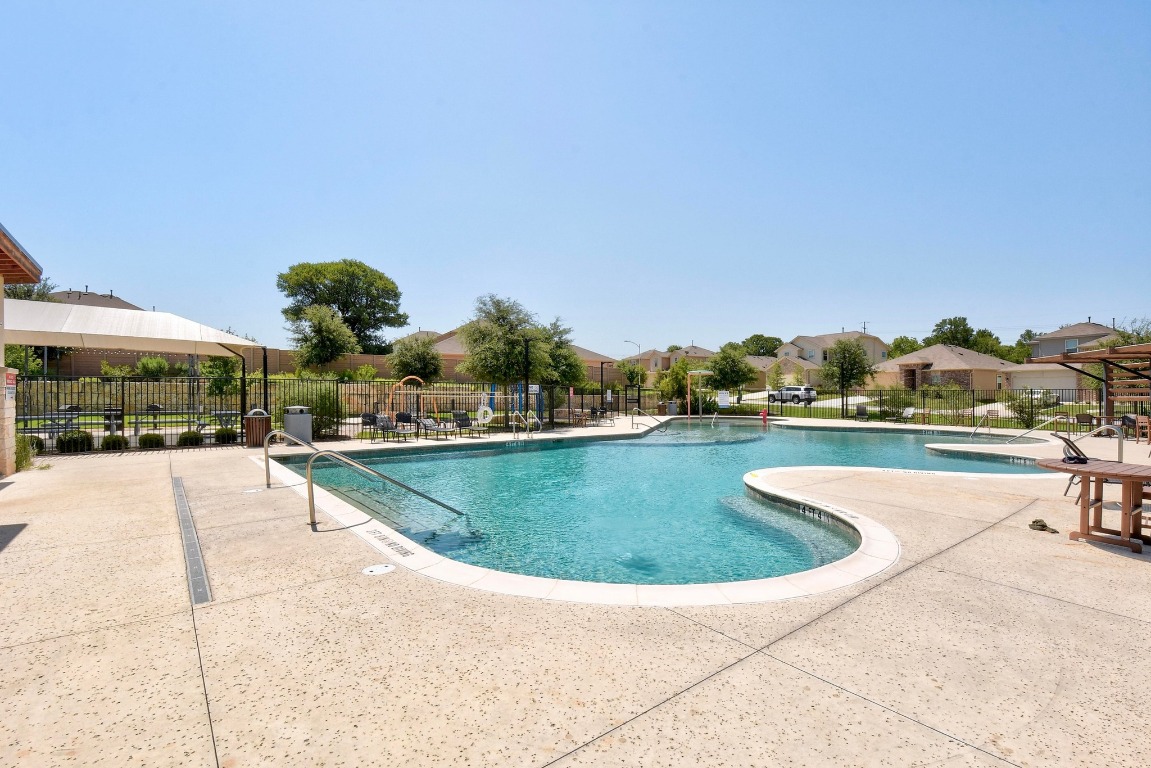 6701 Janes Ranch Road Austin, TX 78744 - Photo 28 of 36 a view of a swimming pool and a yard