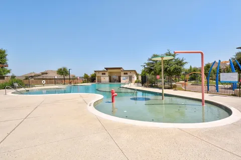 a view of a swimming pool and a yard