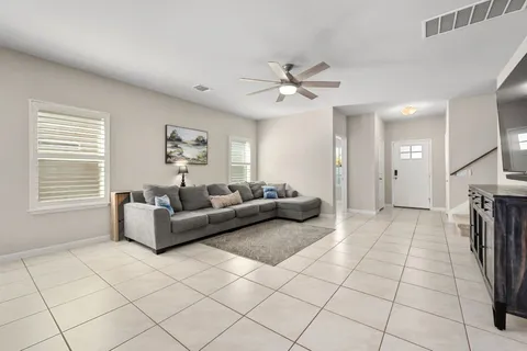 a living room with furniture and a chandelier