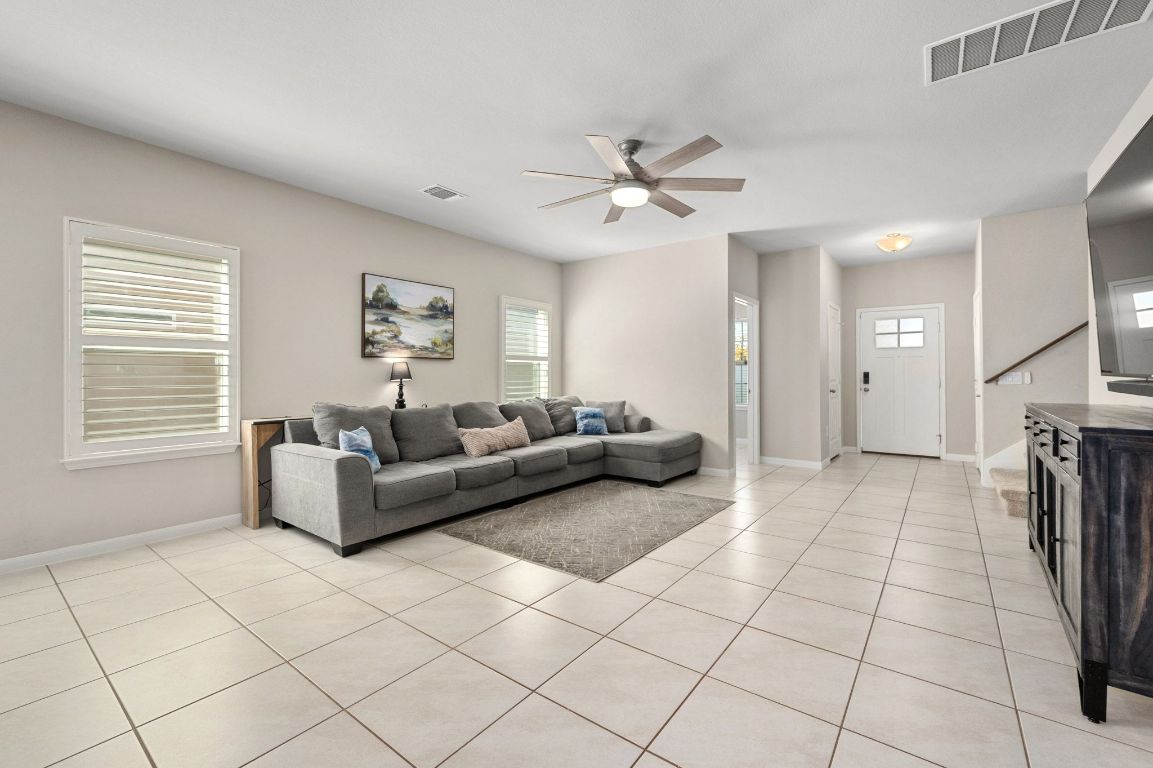 6701 Janes Ranch Road Austin, TX 78744 - Photo 3 of 36 a living room with furniture and a chandelier