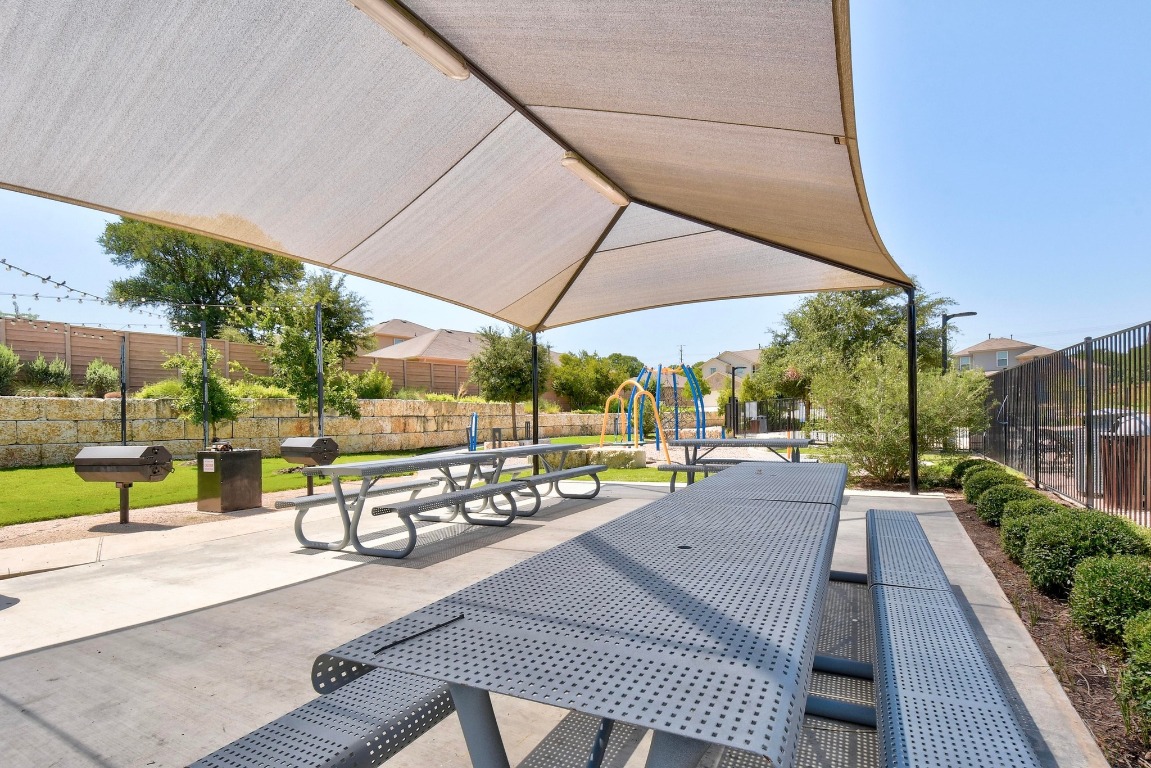 6701 Janes Ranch Road Austin, TX 78744 - Photo 31 of 36 a view of a patio with a table and chairs under an umbrella