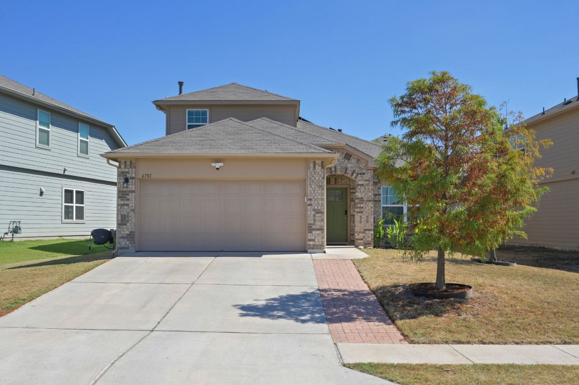 6701 Janes Ranch Road Austin, TX 78744 - Photo 33 of 36 a front view of a house with garden