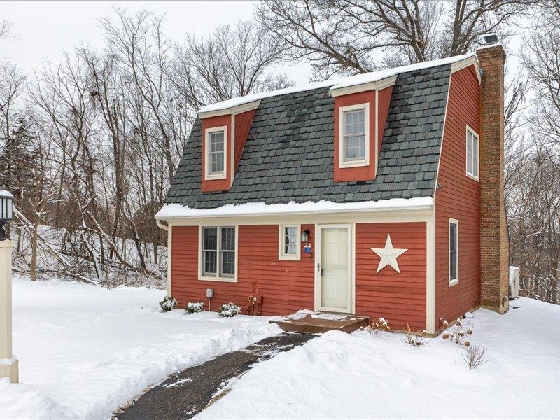 22 Thatcher Lane Galena, IL 61036 - Photo 1 of 24 a front view of a house with a yard covered in snow