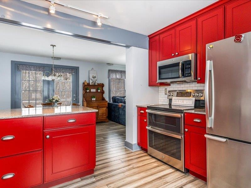 22 Thatcher Lane Galena, IL 61036 - Photo 12 of 24 a kitchen with stainless steel appliances granite countertop a refrigerator stove microwave and sink