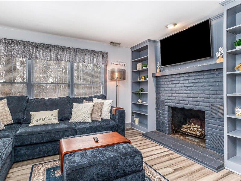 22 Thatcher Lane Galena, IL 61036 - Photo 4 of 24 a living room with a fireplace and a flat screen tv