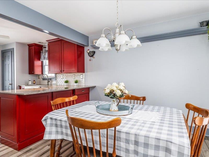 22 Thatcher Lane Galena, IL 61036 - Photo 8 of 24 a dining room filled chandelier and wooden floor
