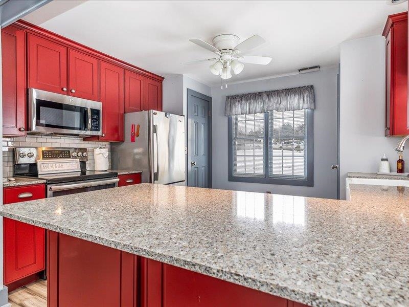 22 Thatcher Lane Galena, IL 61036 - Photo 10 of 24 a kitchen with stainless steel appliances granite countertop a sink refrigerator stove microwave and cabinets