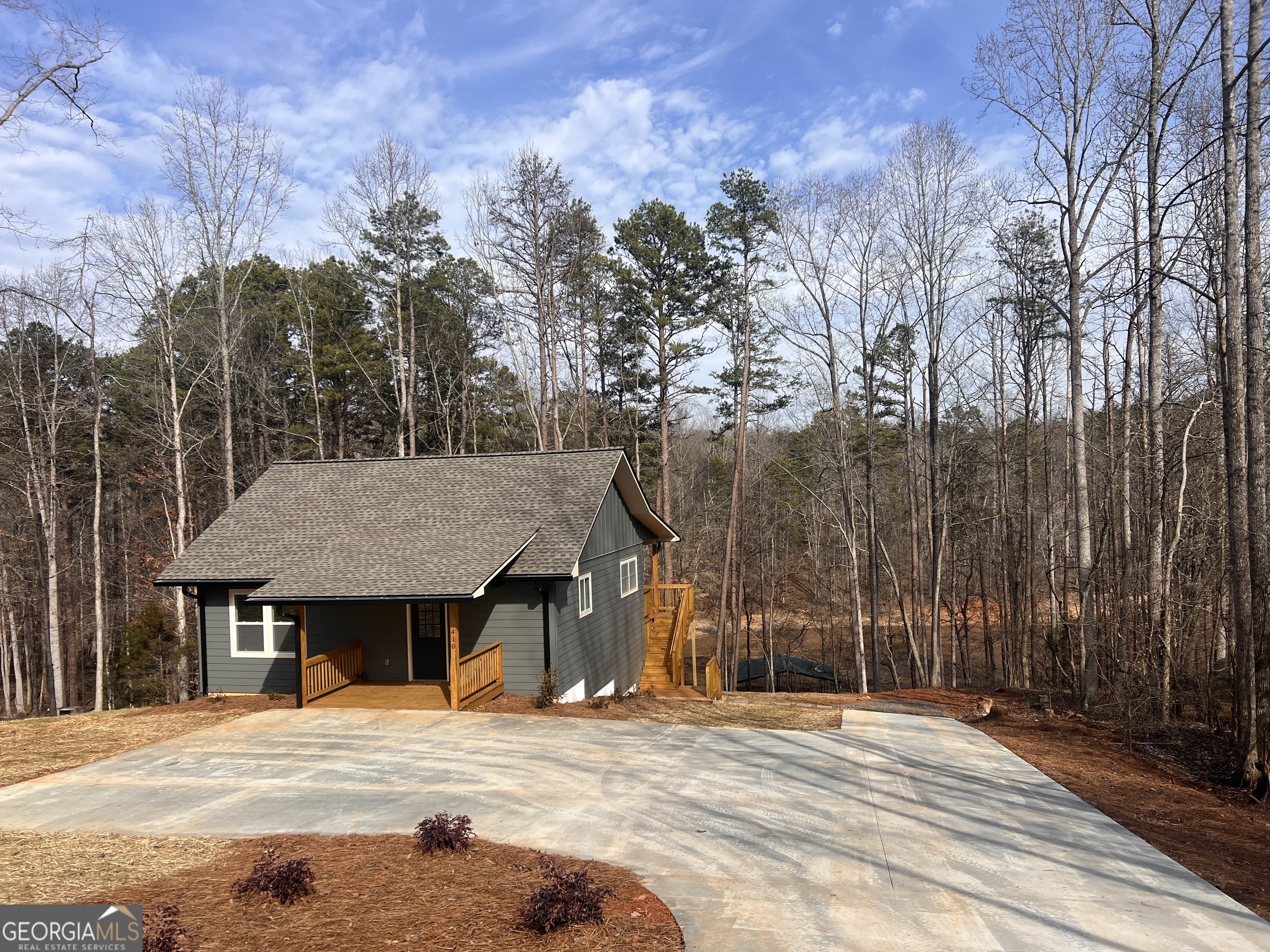 410 Lakeside Hills Road Martin, GA 30557 - Photo 1 of 53 a wooden house with trees in front of it