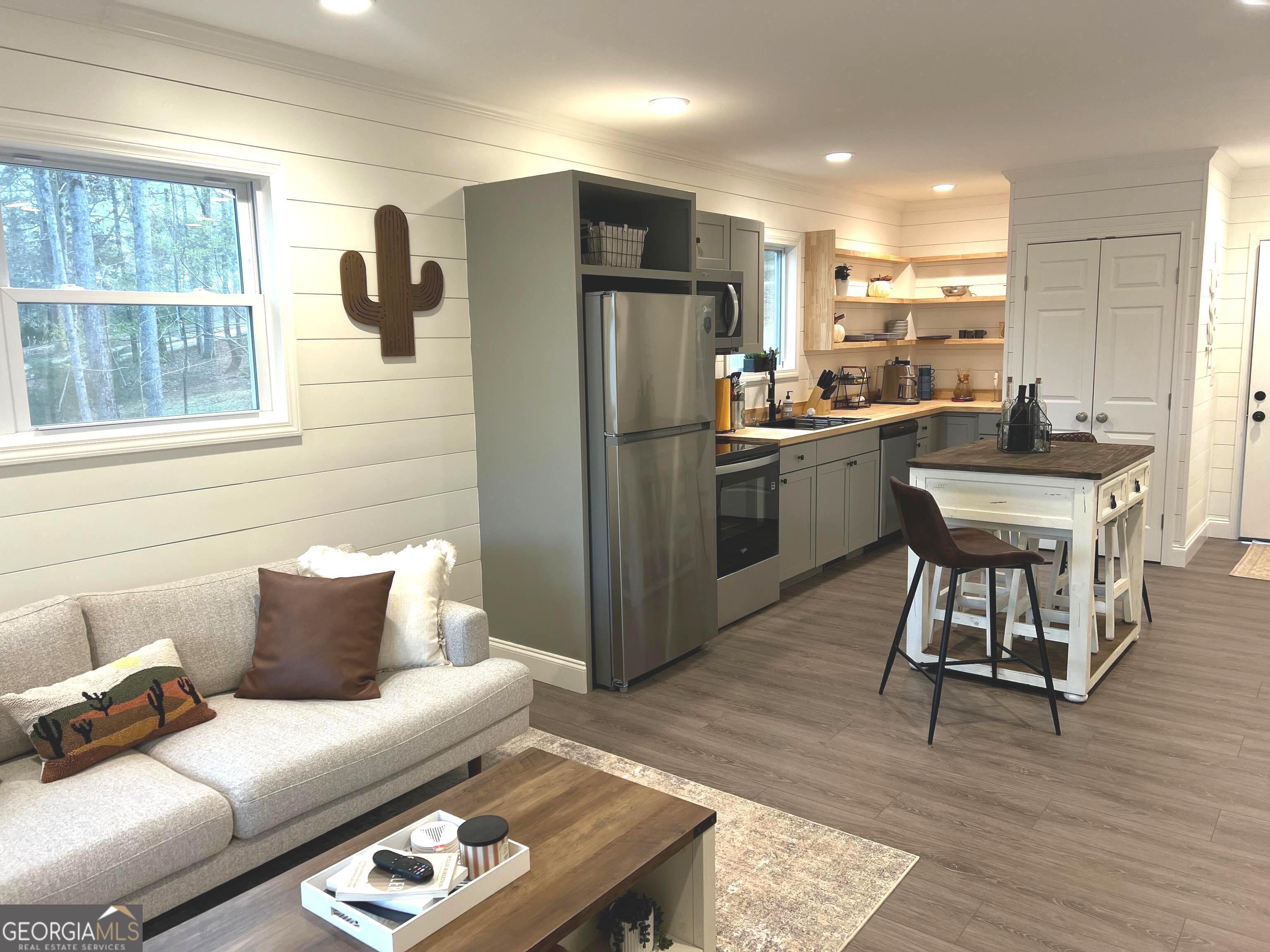 410 Lakeside Hills Road Martin, GA 30557 - Photo 13 of 71 a living room with stainless steel appliances furniture and a wooden floor
